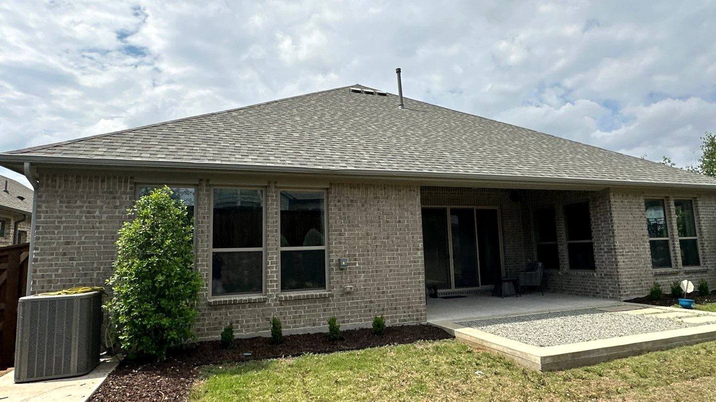 Architectural shingle roof and brick home exterior from a Pioneer Roofing project